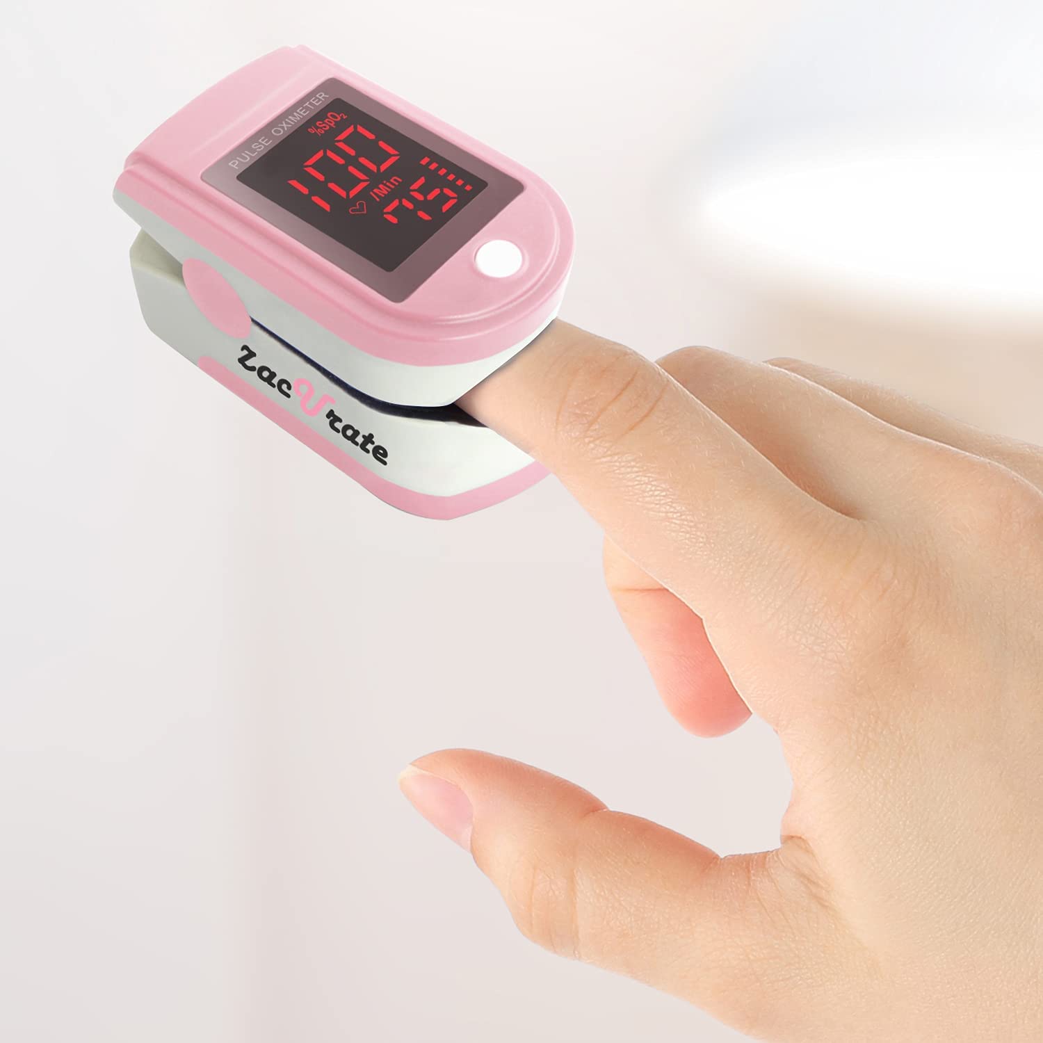  A close-up view of a finger inside of the pink Zacurate 500DL Pro Series Pulse Oximeter 