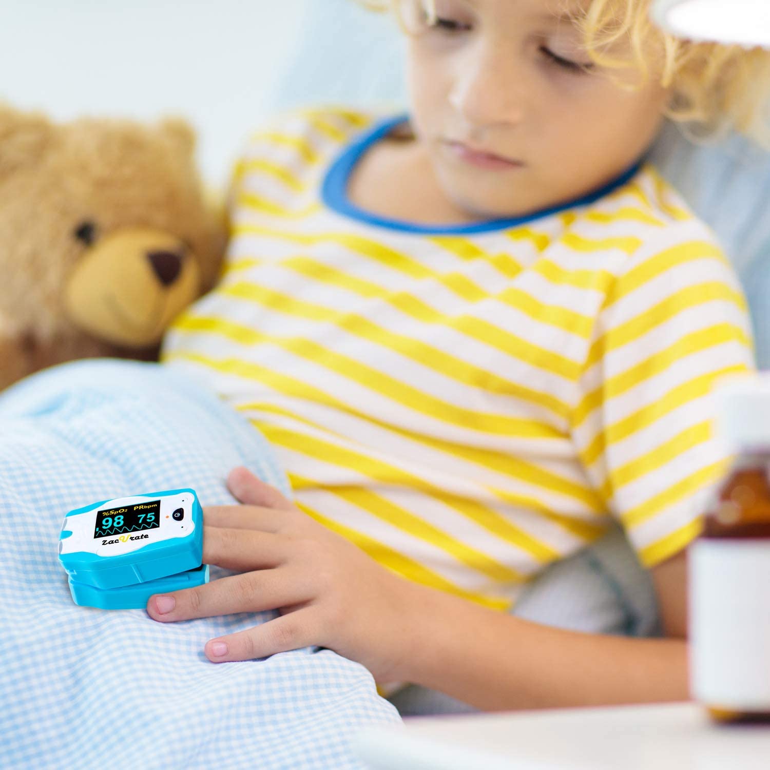 A child on the bed with the Zacurate Children Pulse Oximeter on his finger 