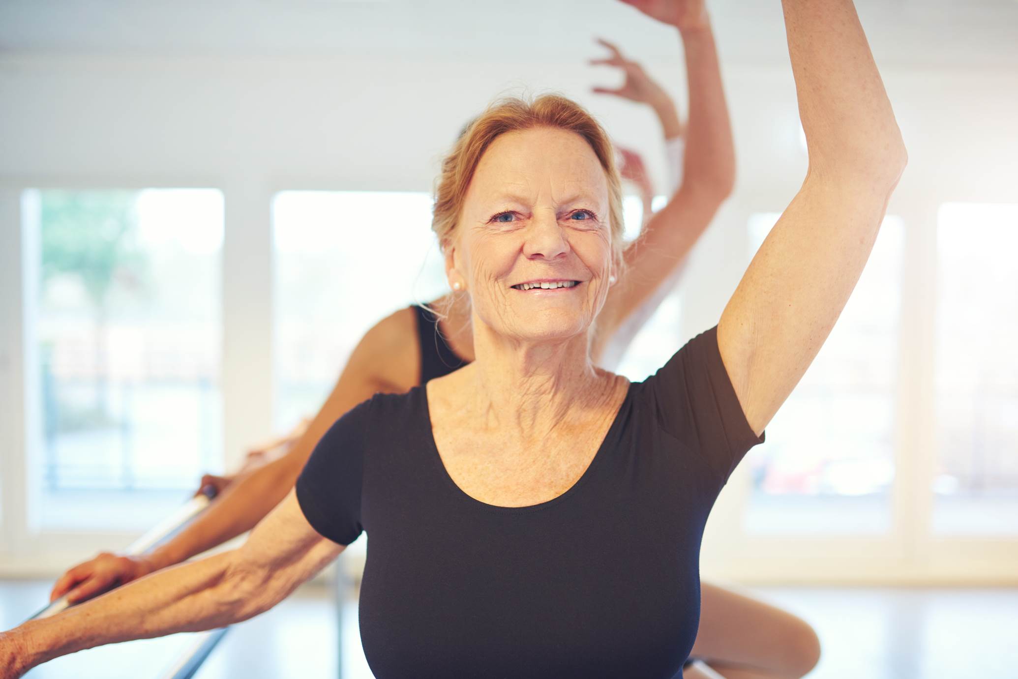  A senior citizen exercising and smiling 