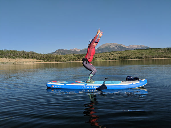 sup yoga chair pose woman lake 