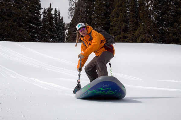 Woman Snow SUP Paddleboard Snowsled Mountains