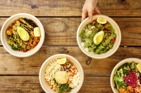 Four bowls with a hand pulling one away