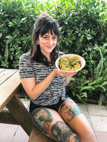 Dana sits at della bowls in The Wynwood Yard, holding her della bowl