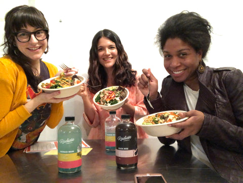Photo with Dana and her 2 team members at the cooking class, holding up their bowls. 