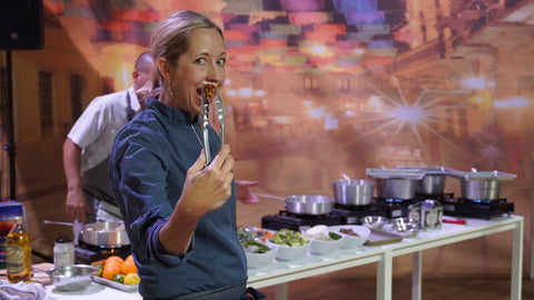 Chef Julie showing a perfectly cooked piece of tempeh at a cooking class