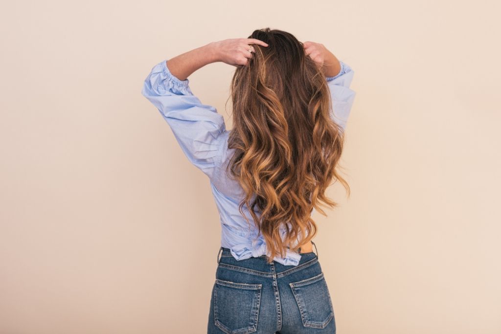 Woman On Orange Background With Long Hair - How To Grow Long hair