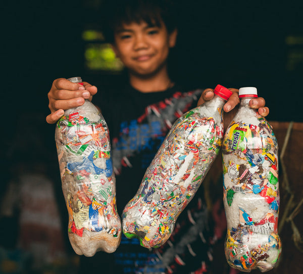 boy holding sample ecobricks