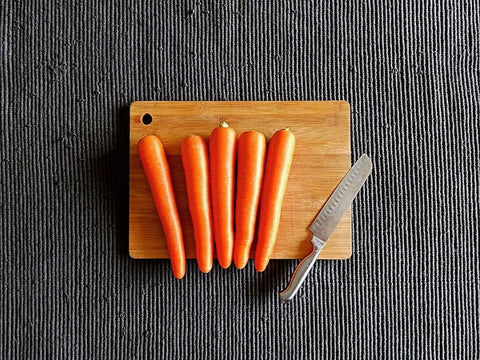 carrots-and-knife-on-wooden-bamboo-chopping-board