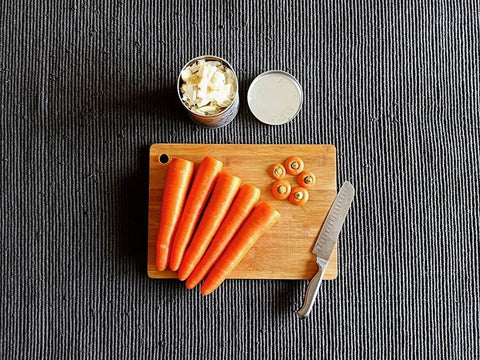 carrots-and-knife-on-wooden-bamboo-chopping-board