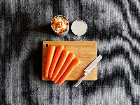 carrots-and-knife-on-wooden-bamboo-chopping-board