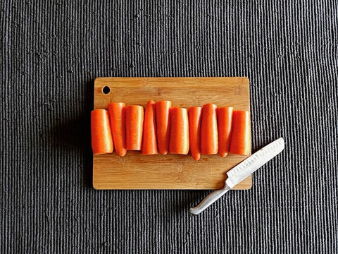 chopped-carrots-and-knife-on-wooden-bamboo-chopping-board