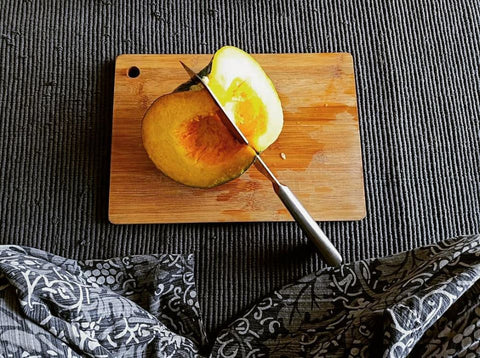 squash-pumpkin-kalabasa-slices-and-knife-on-wooden-bamboo-chopping-board