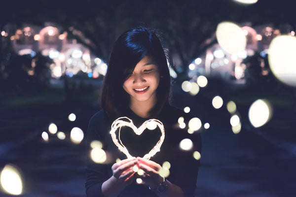 Girl holding heart showing self love