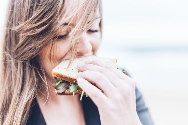 Girl eating healthy brown bread sandwich