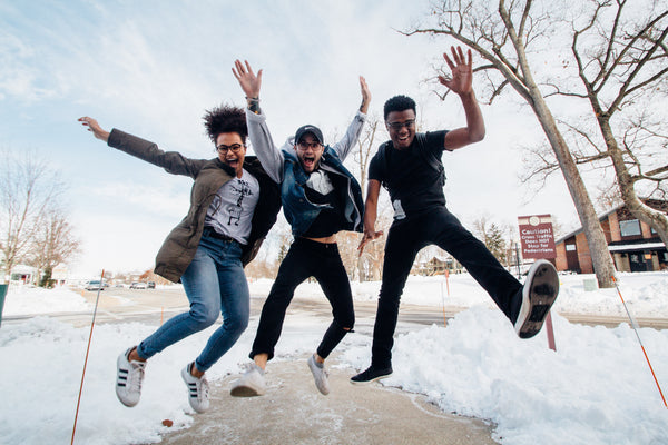 Group of friends jumping in positive way