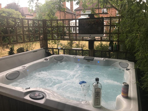 Hot tub with tv and alcohol bottles