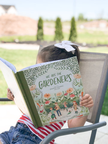 Lizzy reading We are Gardeners