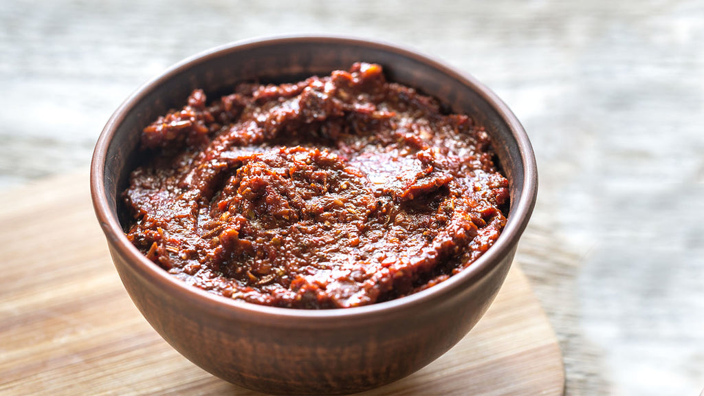 Adobo chicken marinade in a small dish.