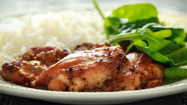 Sweet and sour Hawaiian shoyu chicken with salad and rice.