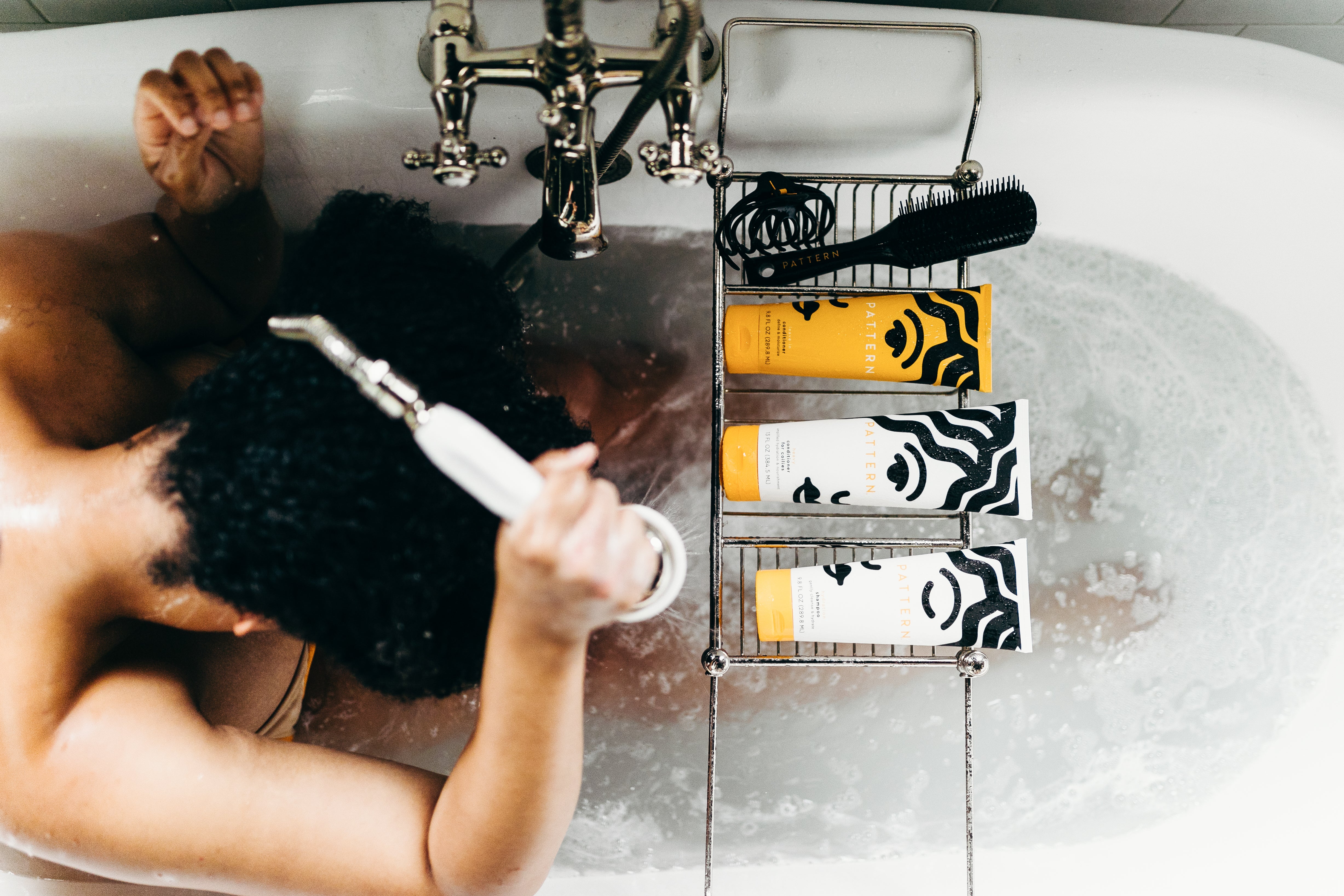 woman washing her hair in bathtub