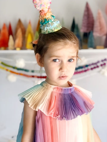 four year old in front of party decorations