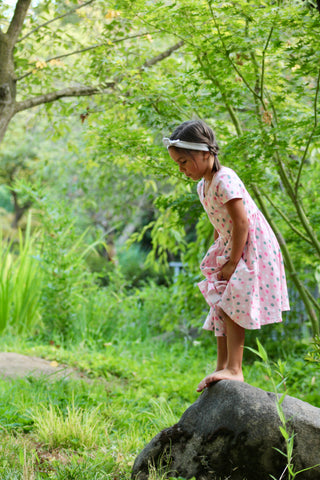 girl standing on rock in twirl dress