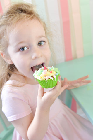 little girl eating her cupcake