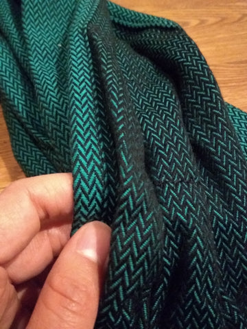 Close up of shoulder strap wrap material of Lenny Hybrid, Lenny Lamb's half buckle meh dai carrier, in Emerald, a green herringbone print