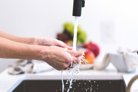 washing-hands-under-sink-faucet-kitchen