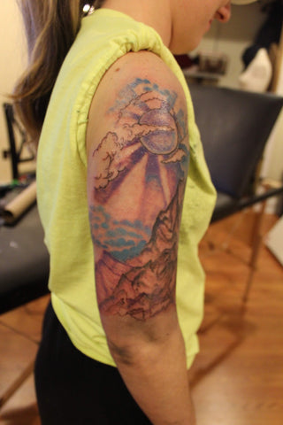 Multi color mountain range tattoo