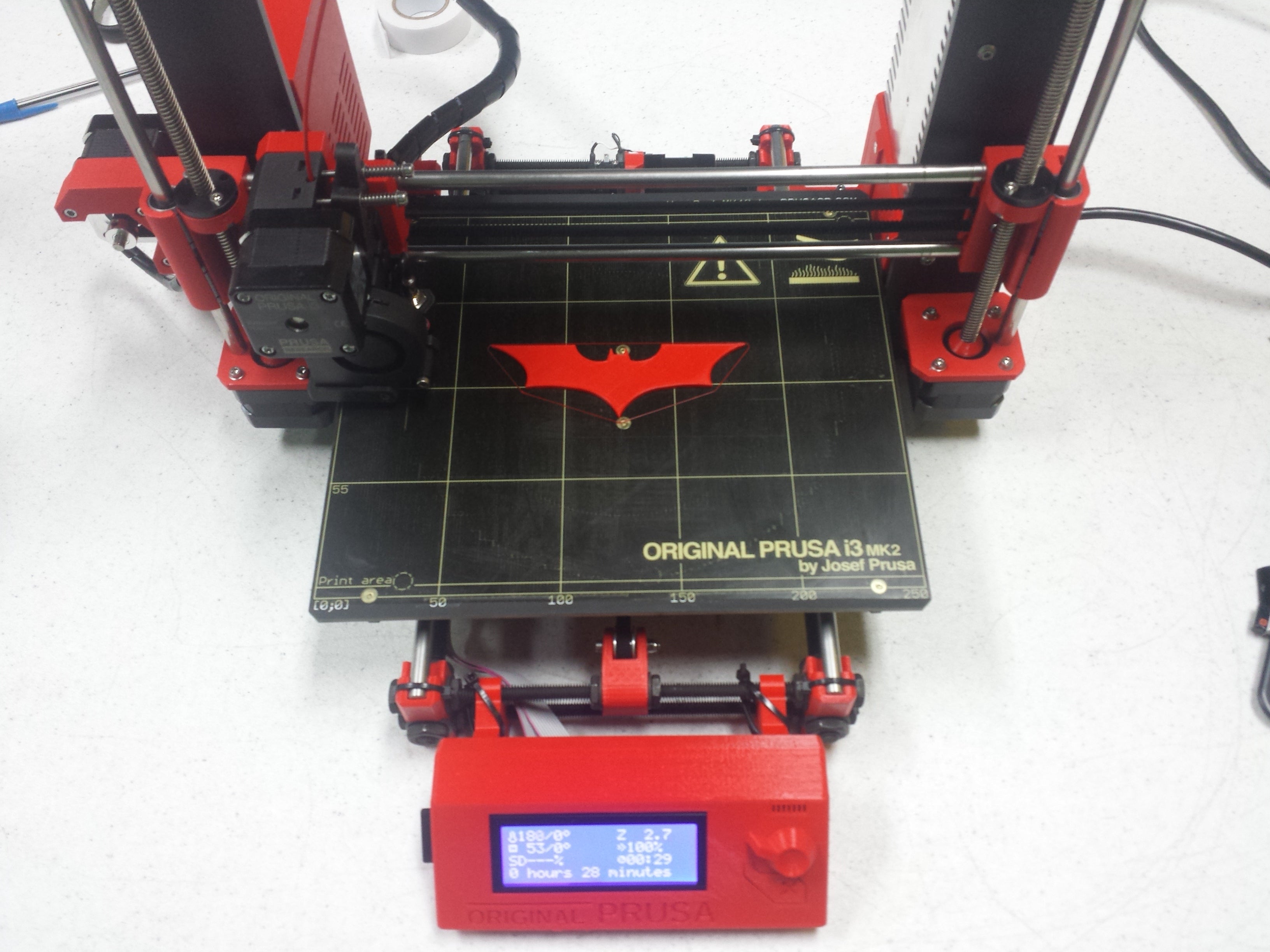 Picture of Original Prusa i3 MK2 red 3D printer printing Batman symbol