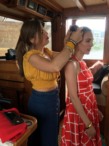 kelly styling maria's hair on our photoshoot on a vintage yacht in seattle