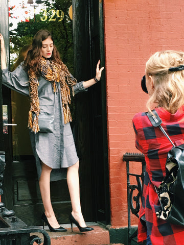 alli in the doorway modeling grey cross body bag