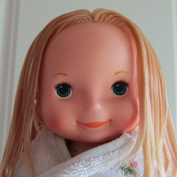 doll with hair combed smooth and ready for curlers