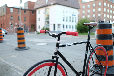 The Baron Regal Bicycle's Red and Black Bicycle in an Urban Setting