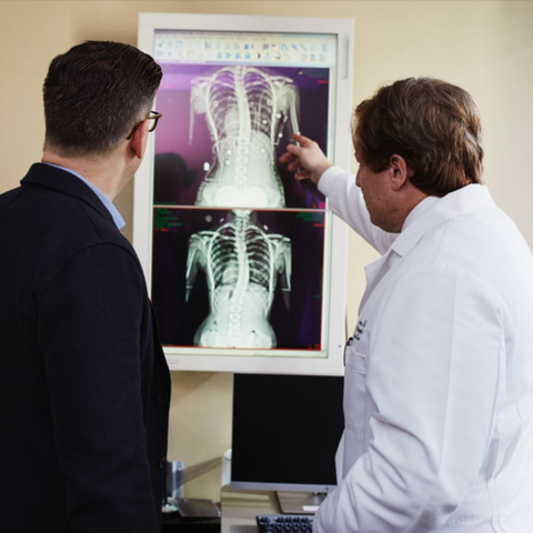 Doctor and patient discussing xray results from spine