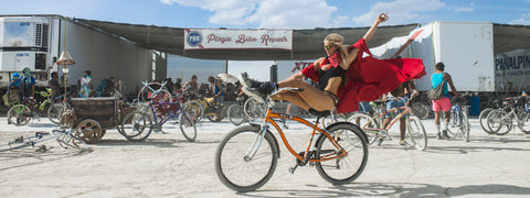 Beautiful person on a bike in front of Playa Bike Repair