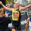 Steve Edwards VOOM ambassador crossing marathon finish line, arms aloft