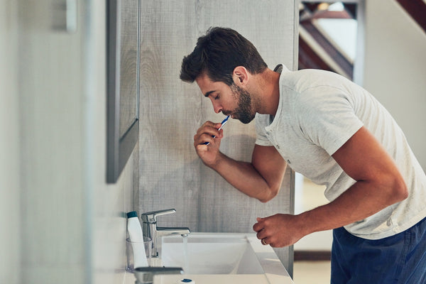 man brushing teeth