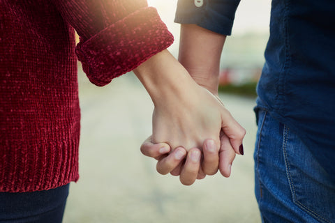 closeup of couple holding hands