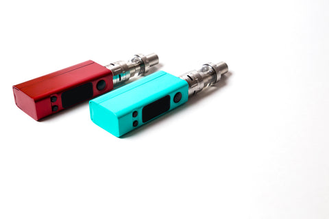 colored vape atomizer boxes on white surface closeup