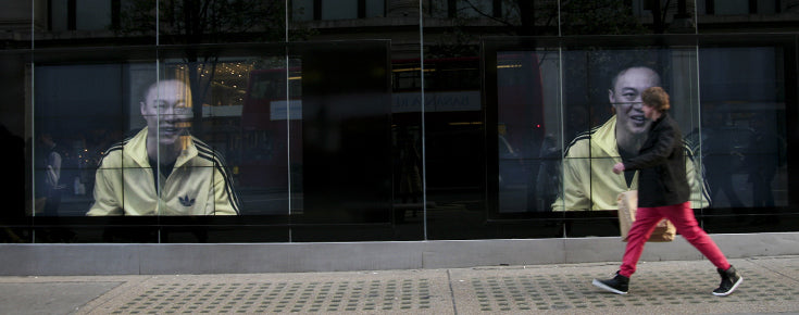 Person walking and looking at a Digital window display