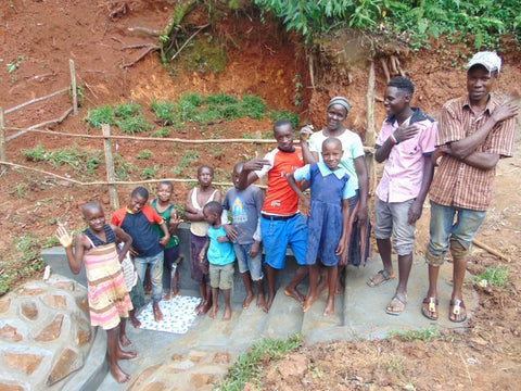 Community members confidently celebrate protected Imbwaga Spring, breaking “the water curse”