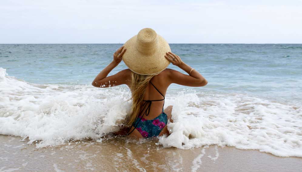 girl in a sunhat at the beach on maui