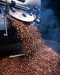 Roasted coffee falling from roaster