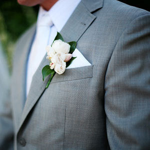 Man wearing a grey tuxedo with a boutonniere