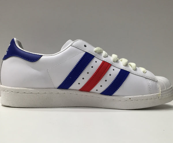 white adidas shoes with blue and red stripes