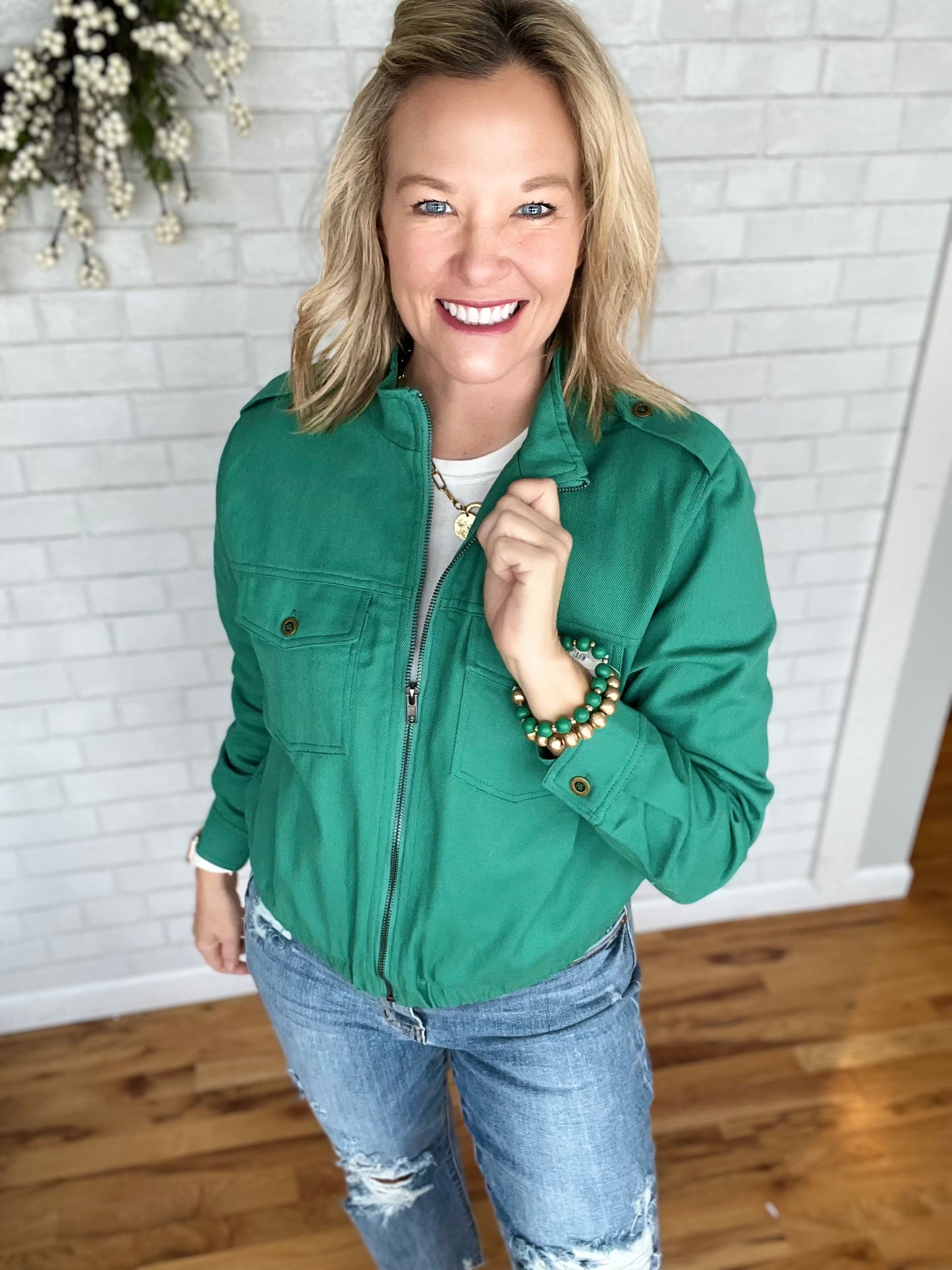 Cute denim jacket in a variety of colors. Features ziop front, stand up collar, epoaulets at shoulder and elasticized waistband. Fit is true to size.