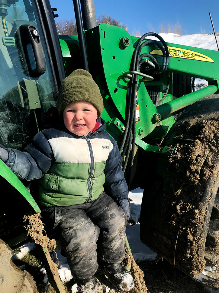barett on tractor in his winter coat and hat