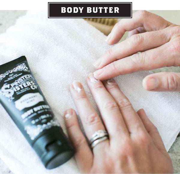 A woman applies Body Butter from a tube to her cuticles